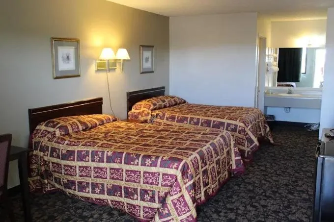 Bed in Travelers Inn & Suites