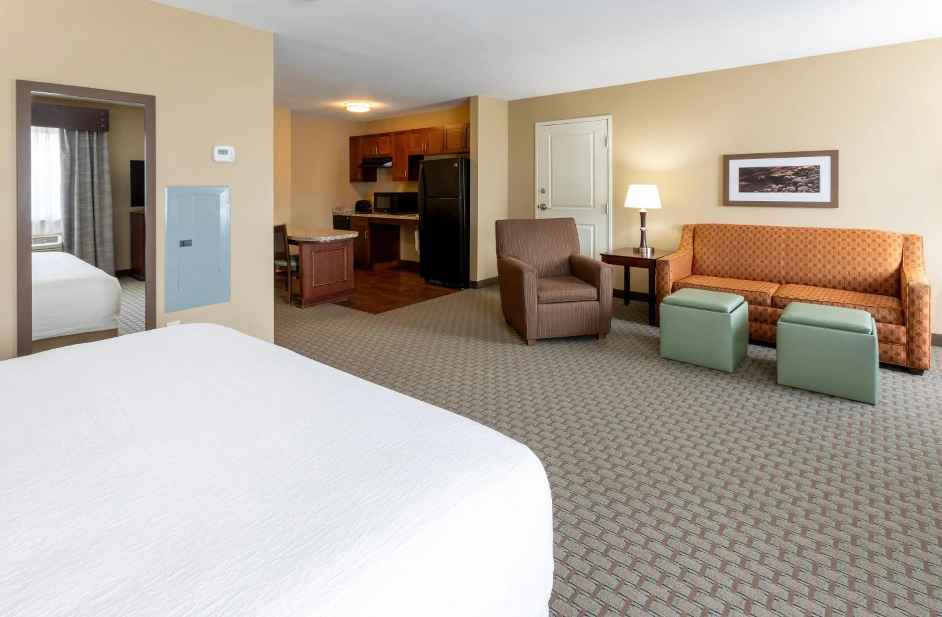 Kitchen or kitchenette, Bed in GrandStay Hotel & Suites - Morris