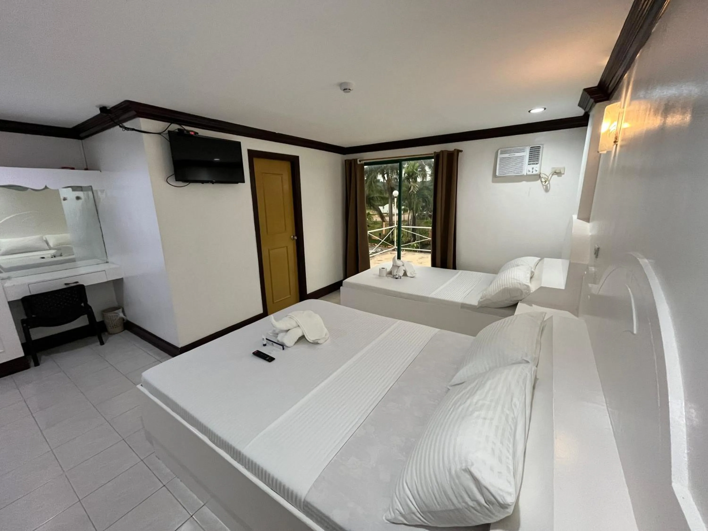 Bed in The Waterfront Beach Resort