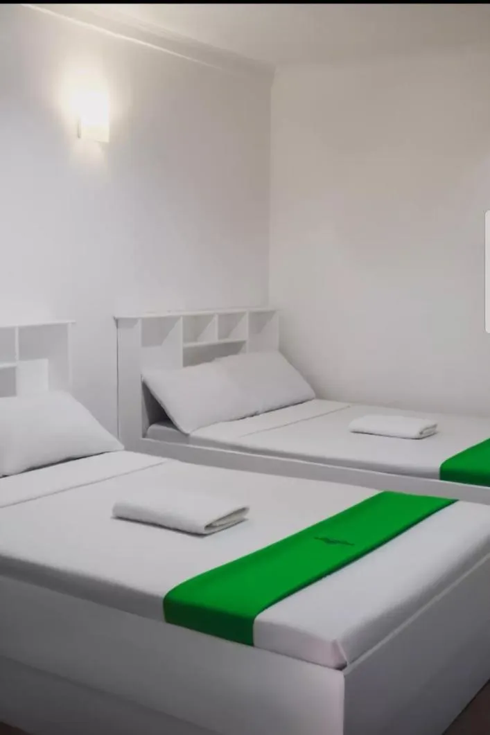 Bed in The Waterfront Beach Resort