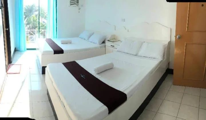 Bed in The Waterfront Beach Resort