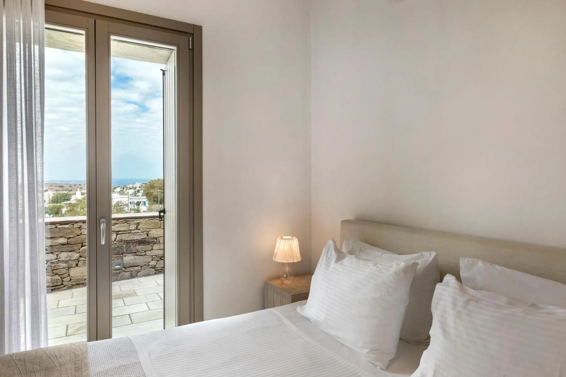 Bed in White Tinos Luxury Suites