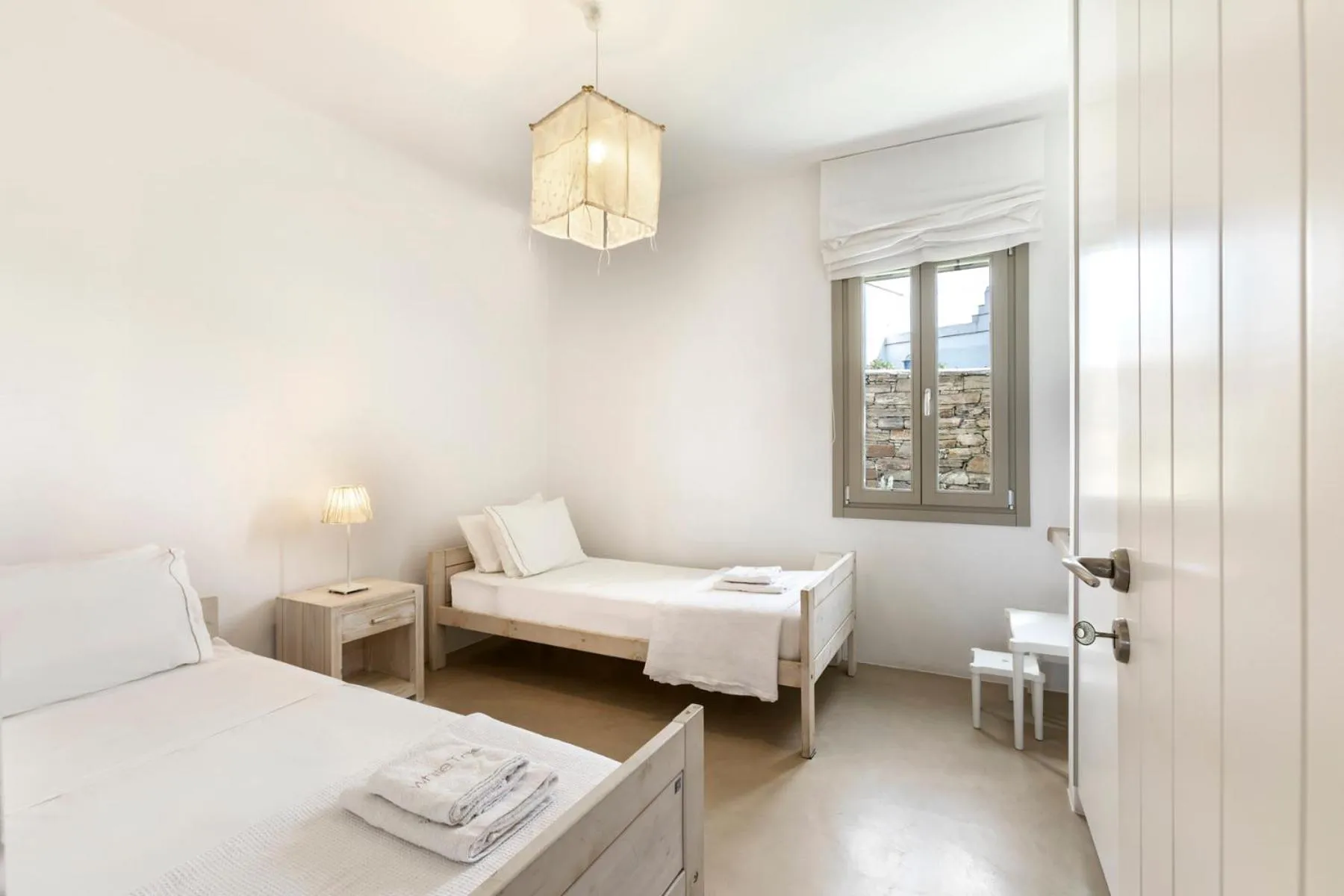 Bed in White Tinos Luxury Suites