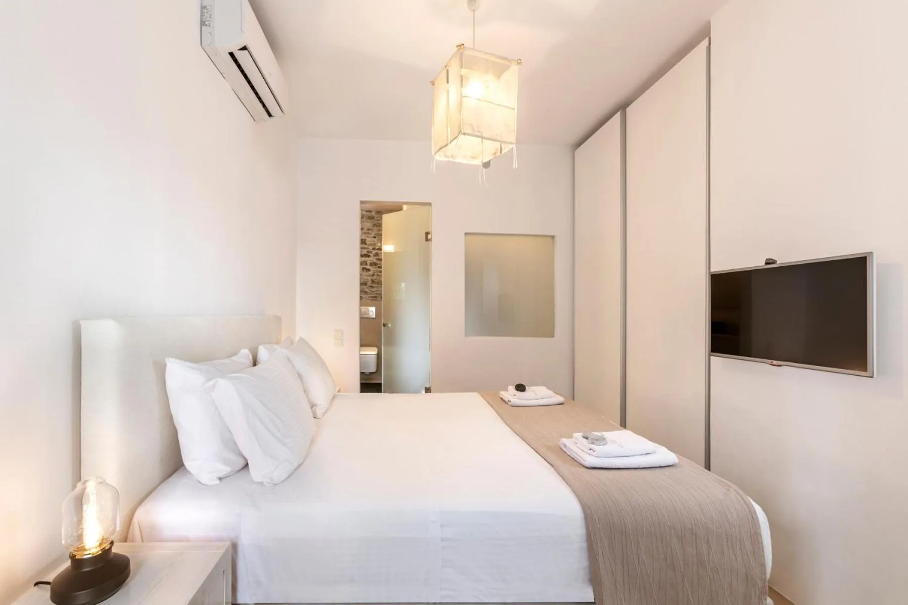 Bed in White Tinos Luxury Suites