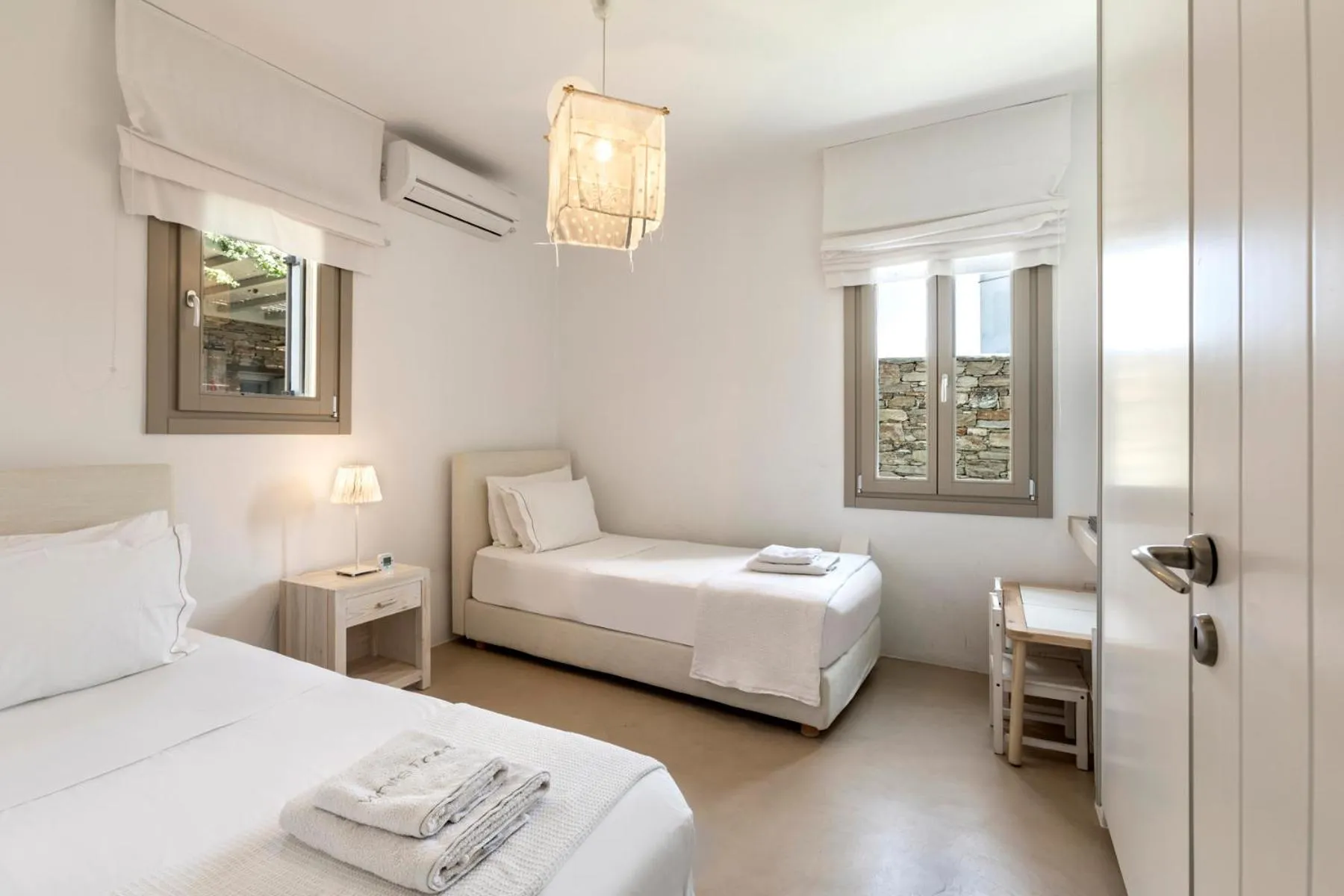 Bed in White Tinos Luxury Suites