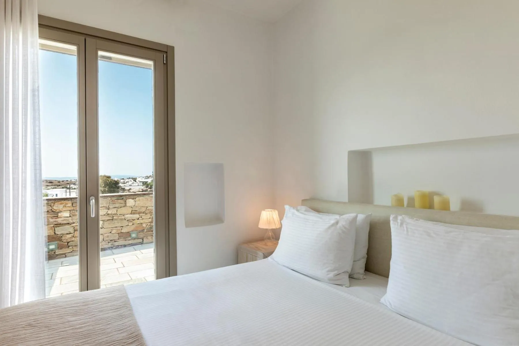 Bed in White Tinos Luxury Suites