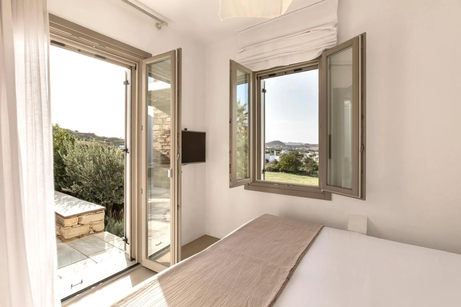 Bed in White Tinos Luxury Suites