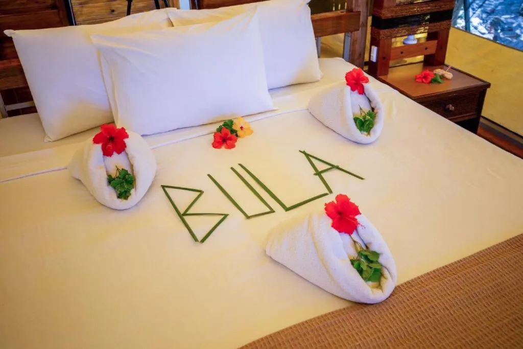Bed in Barefoot Kuata Island Resort