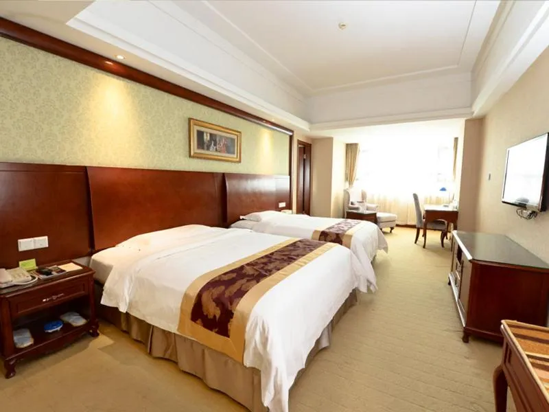 Bed in Vienna International Hotel Shanghai Hongqiao Hub International Exhibition Center