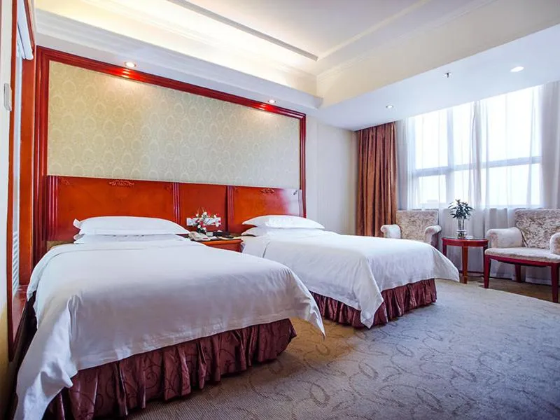 Bed in Vienna International Hotel Shenzhen Songgang Wanzhao Square
