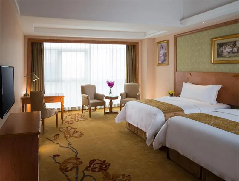 Bed in Vienna International Hotel Shenzhen Longgang Lilang