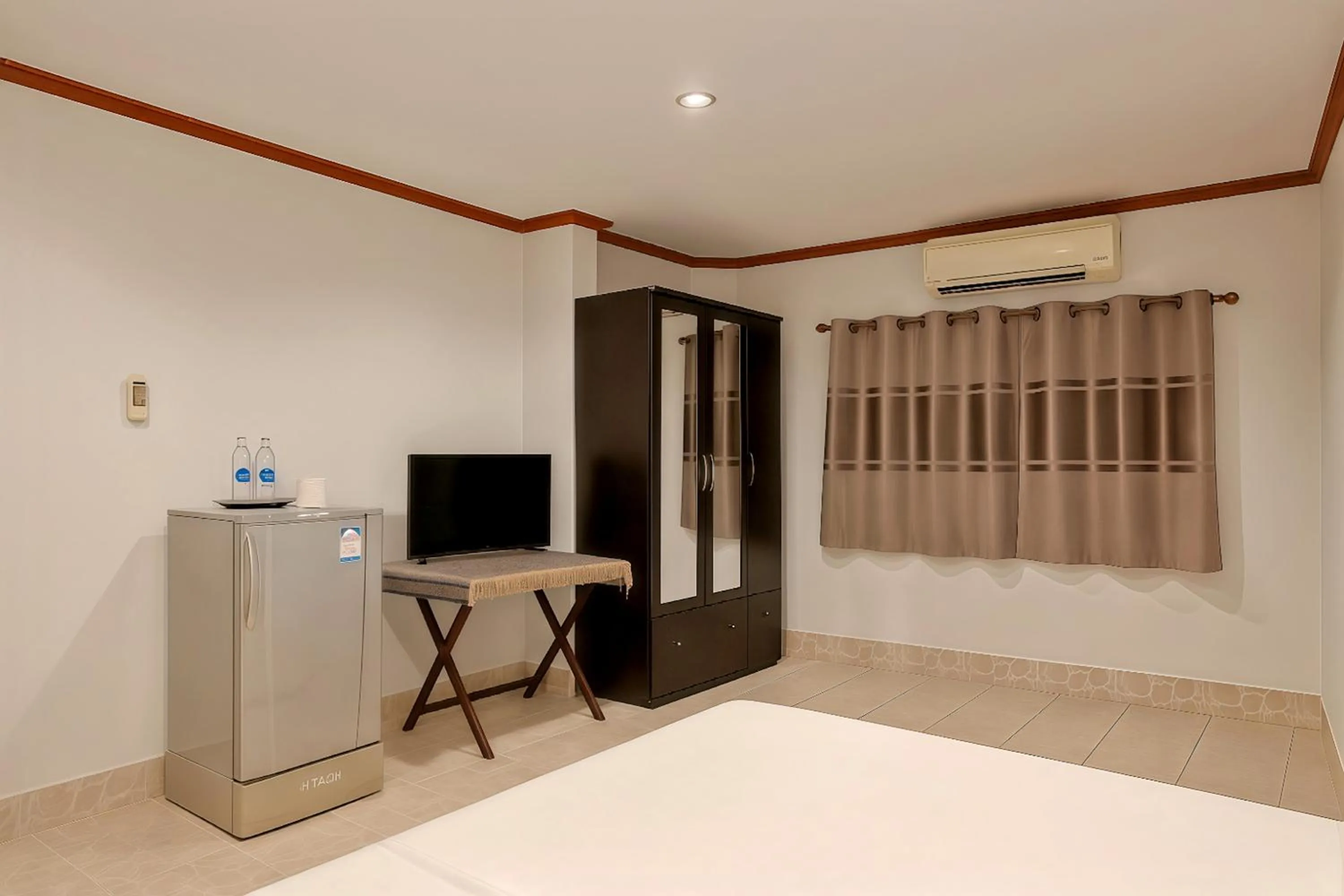 Bed in Kamala Orchid Guesthouse