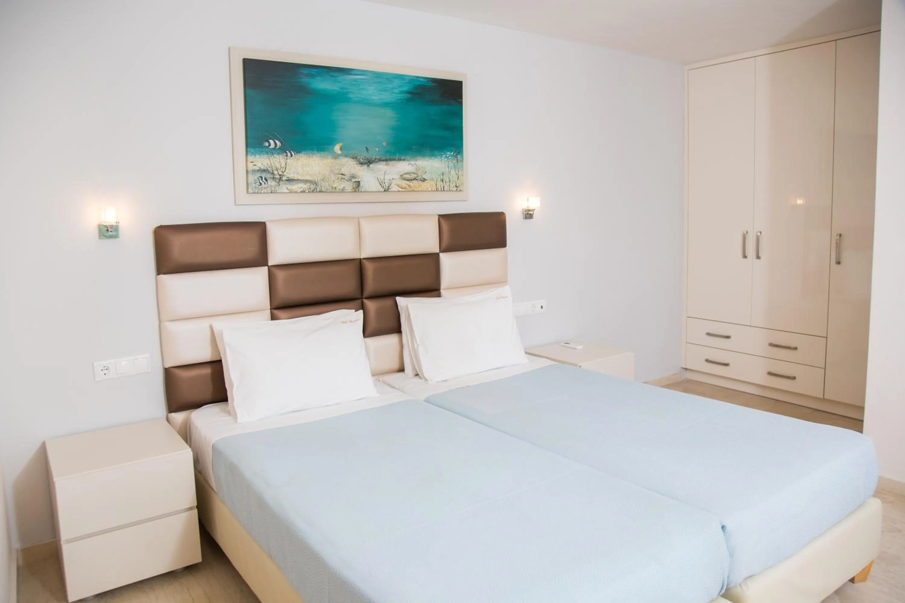 Bed in Brentanos Apartments - A - View of Paradise