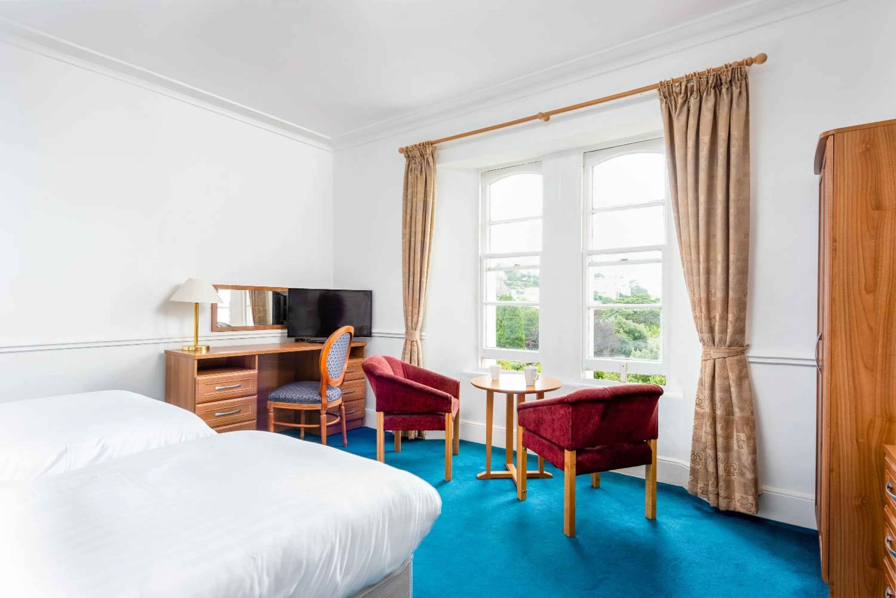 Bed in Abbey Lawn Hotel