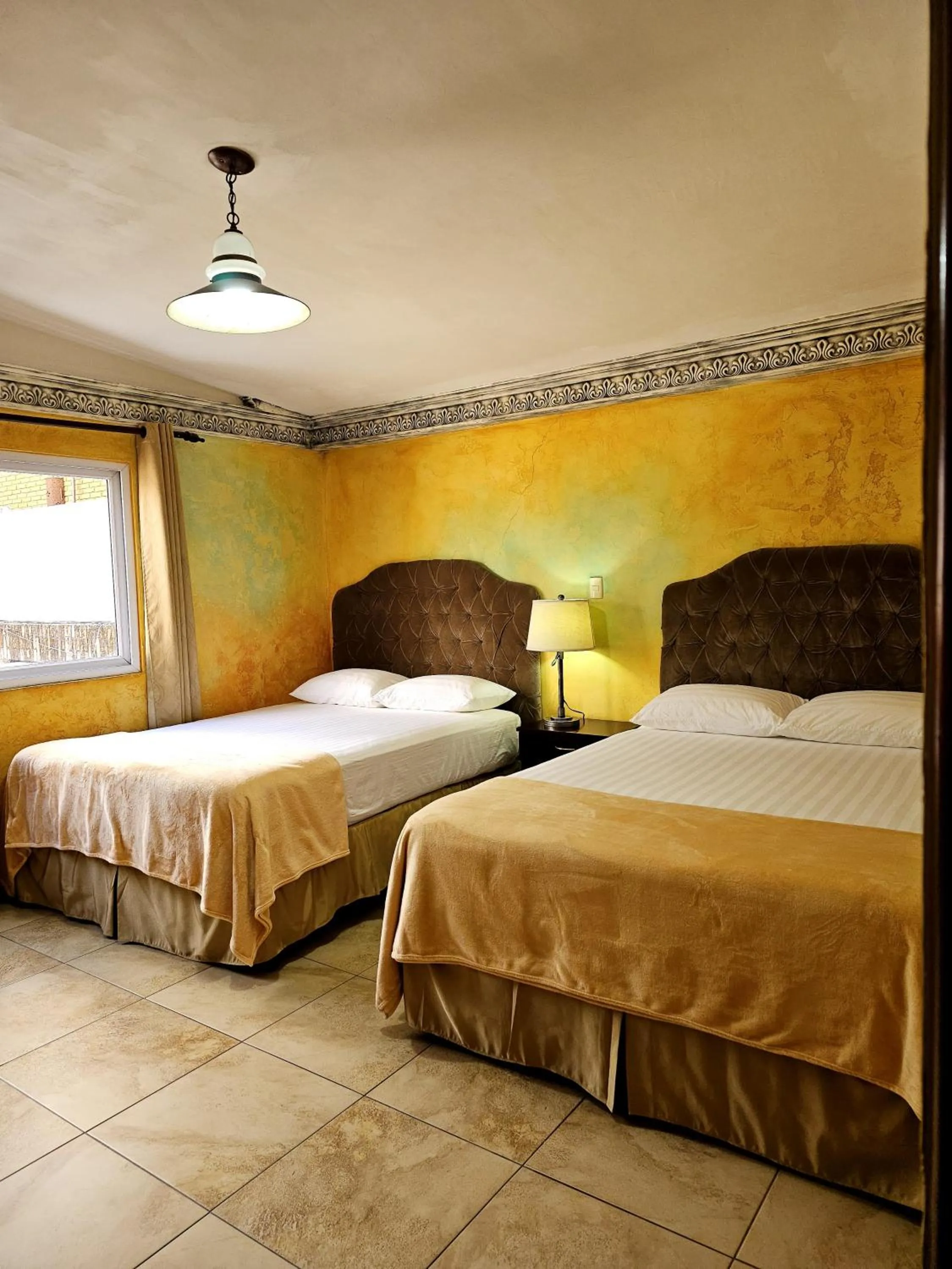 Bed in Antigua Inn Hotel