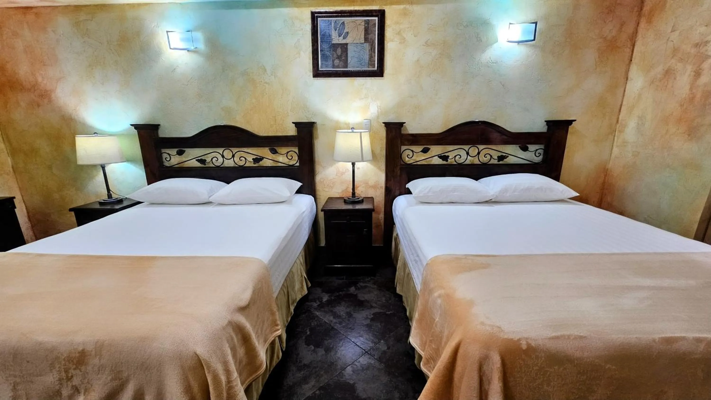 Bed in Antigua Inn Hotel