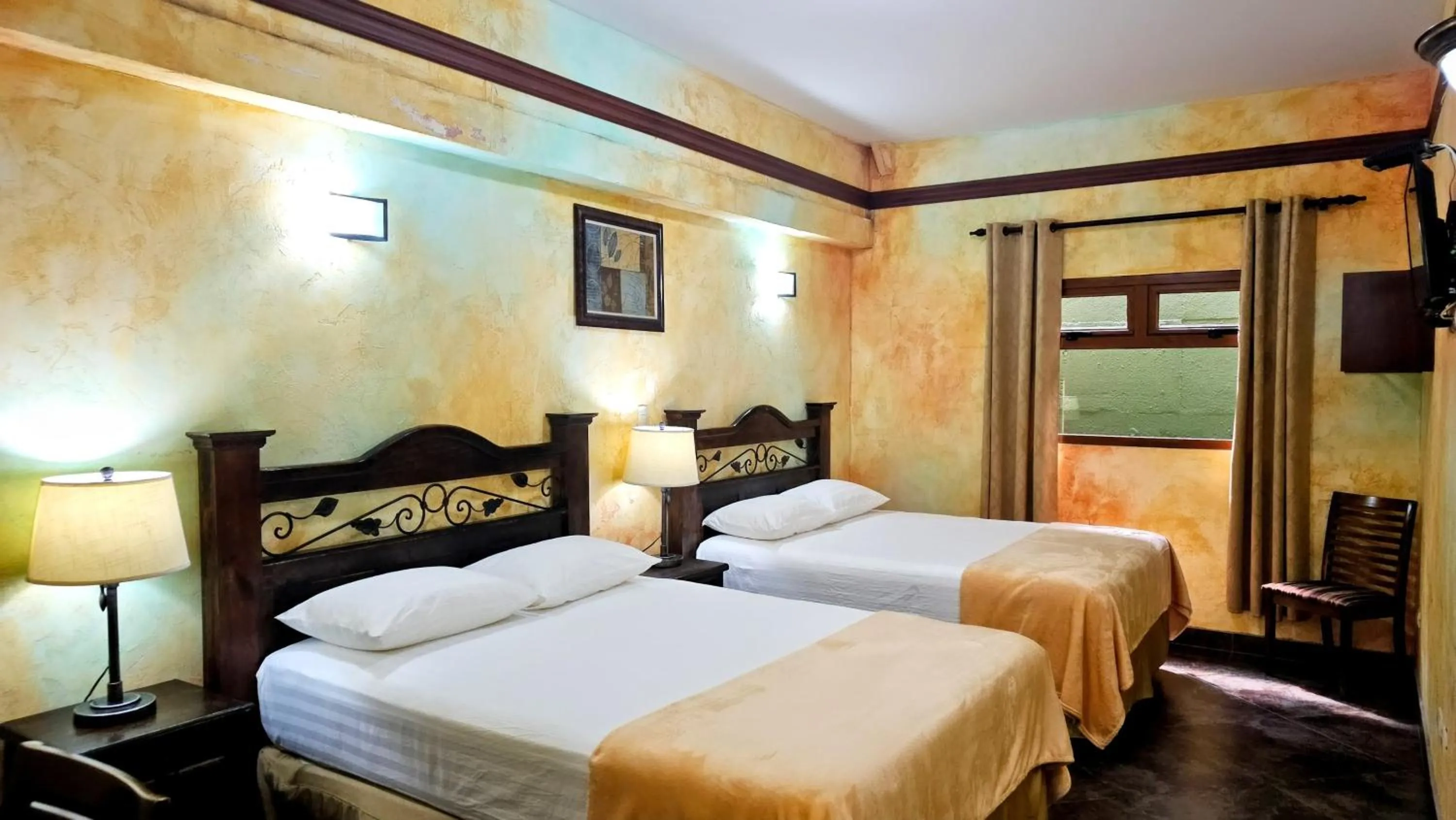 Bed in Antigua Inn Hotel