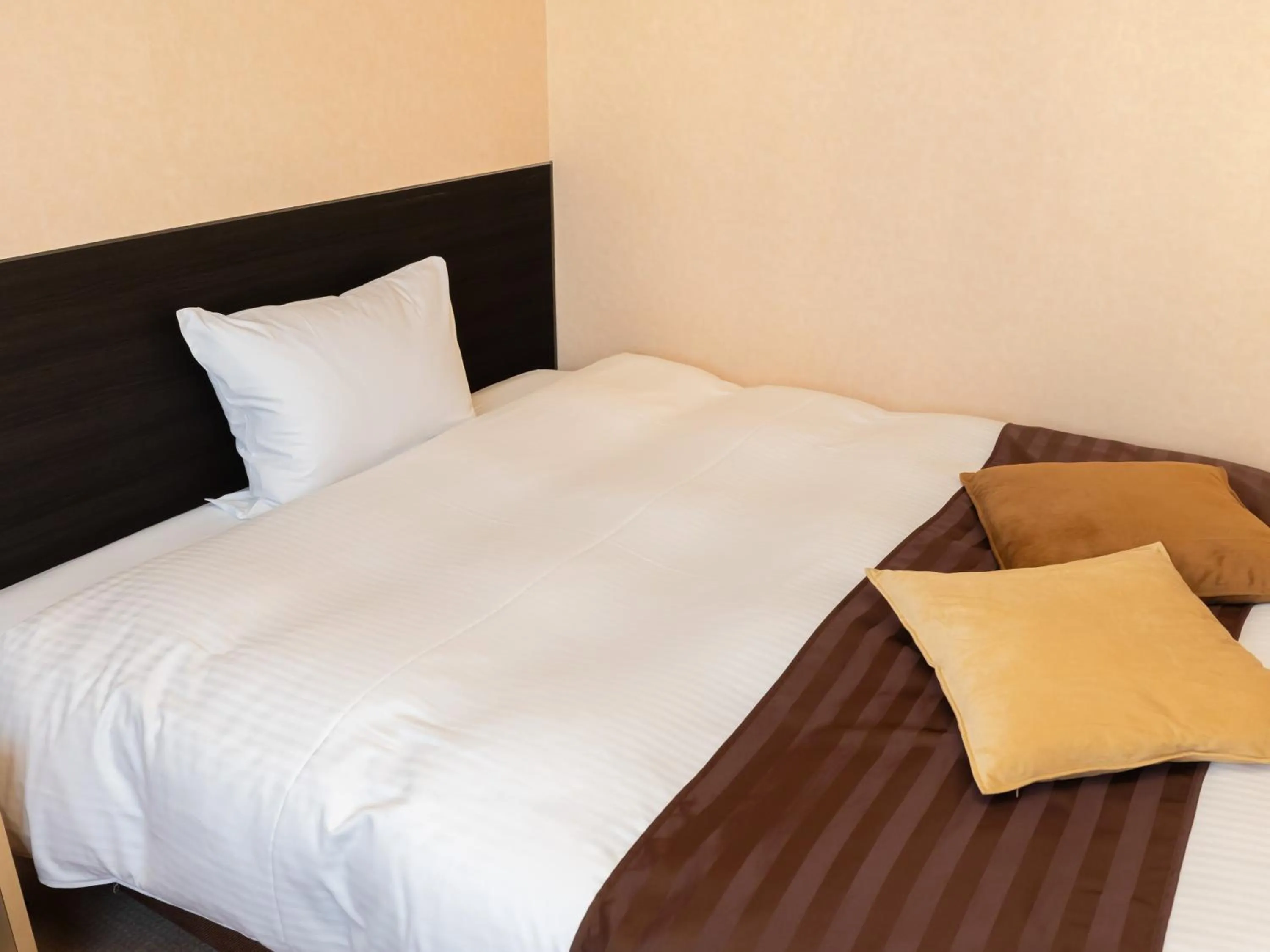 Bed in Tabist Hirosaki Touei Hotel