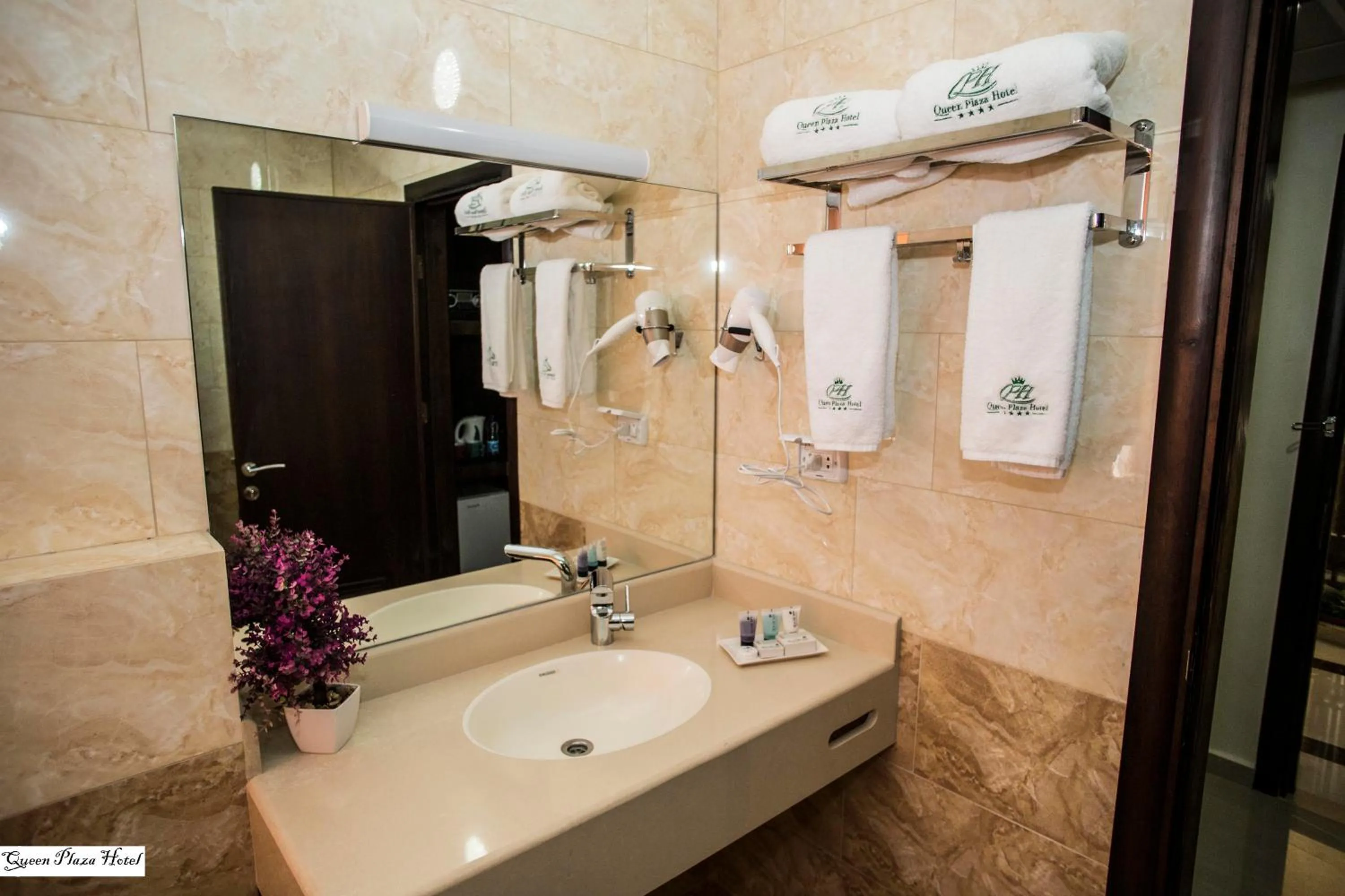 Bathroom in Queen Plaza Hotel
