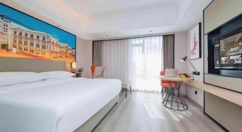 Bed in Vienna International Hotel Wuhan Huanghelou Pengliuyang Metro Station