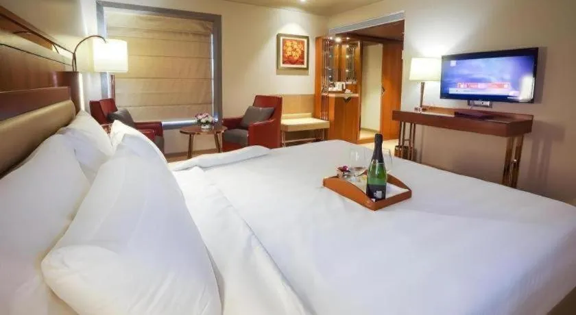 Bed in The Grandeur Boutique Hotel