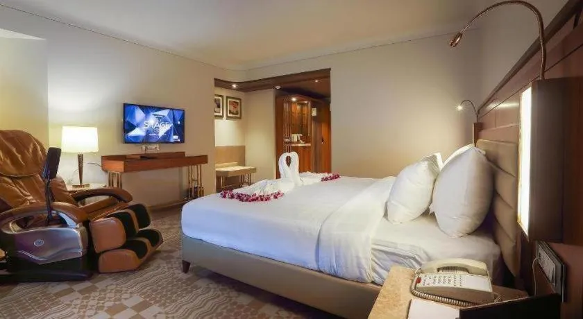 Bed in The Grandeur Boutique Hotel