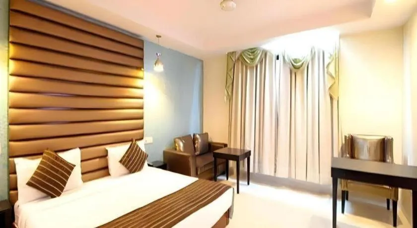 Bed in Hotel Signature Grand