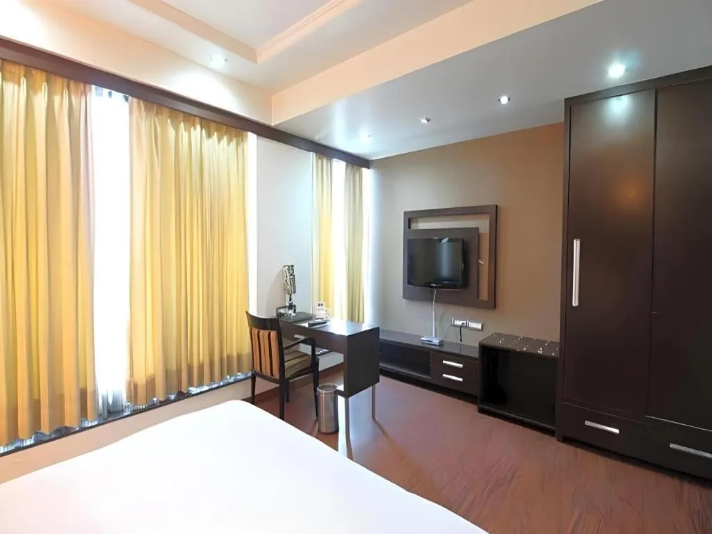 Bed in Hotel Signature Grand