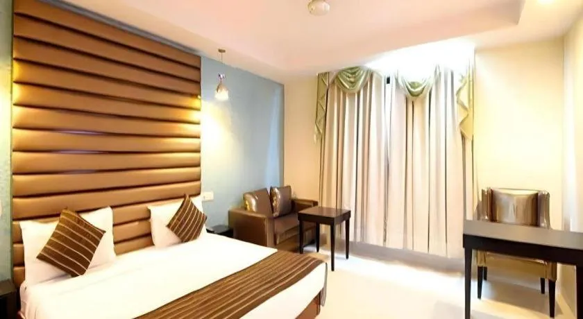 Bed in Hotel Signature Grand