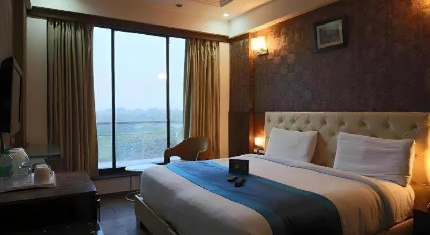 Bed in Hotel Signature Grand