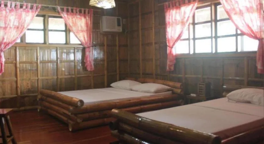 Bed in Nataasan Beach Resort and Dive Center