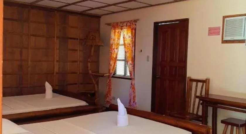 Bed in Nataasan Beach Resort and Dive Center