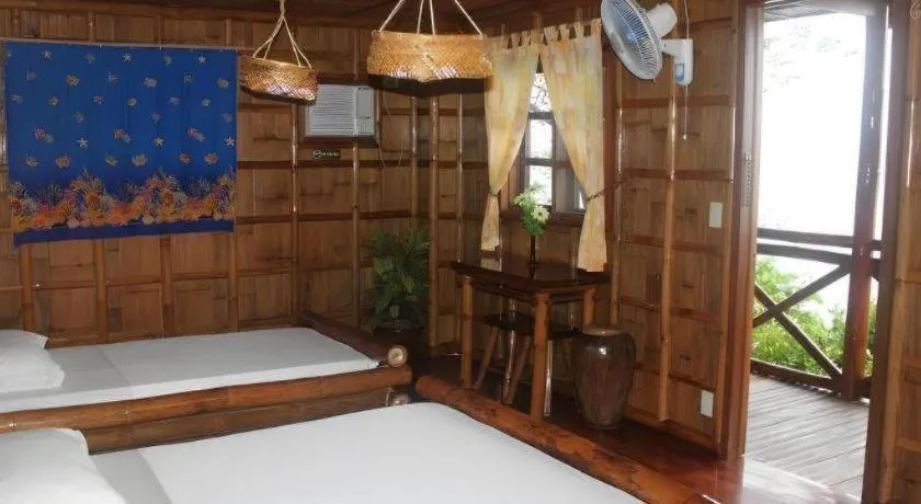 Bed in Nataasan Beach Resort and Dive Center