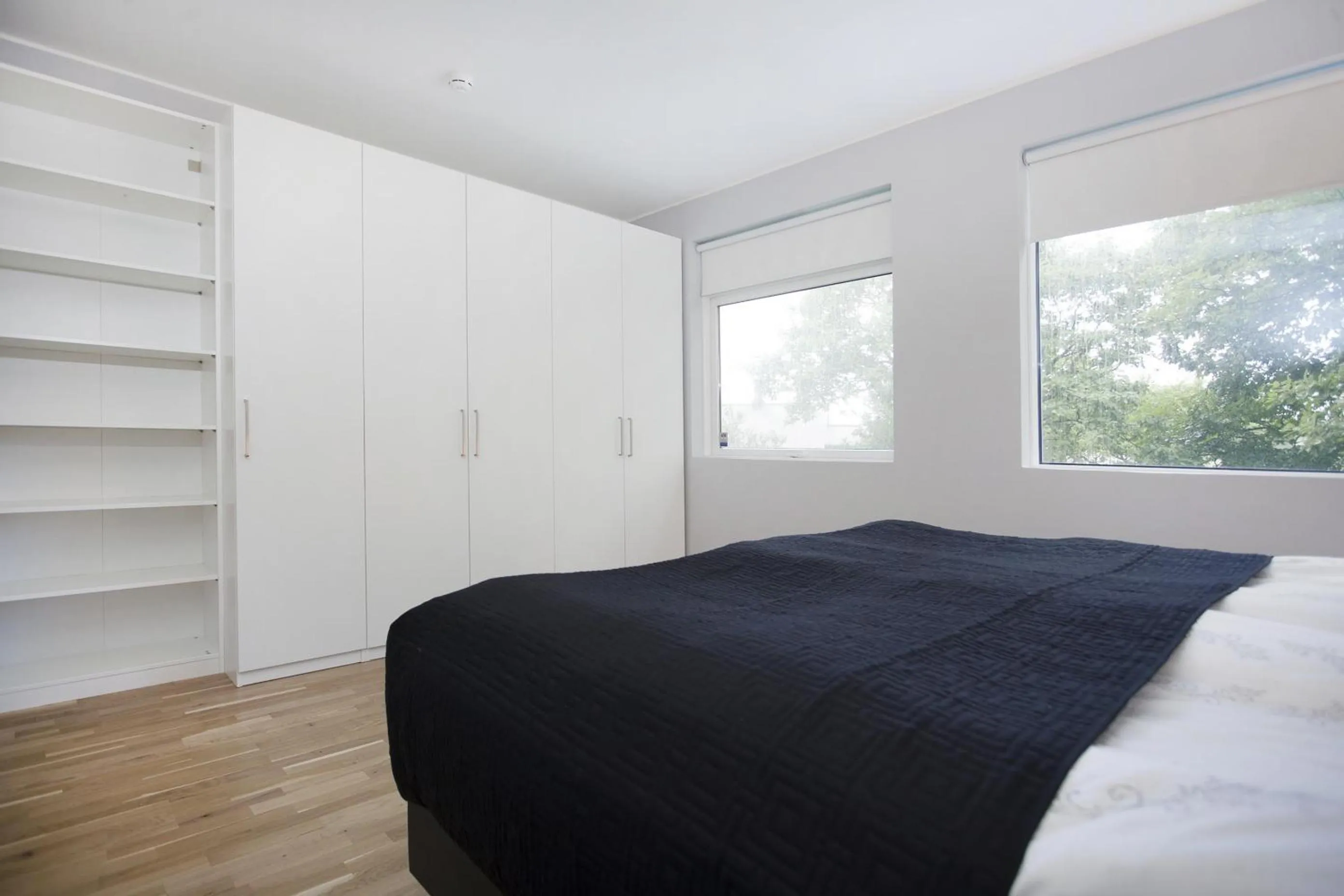 Bed in Blue Luxury Apartments