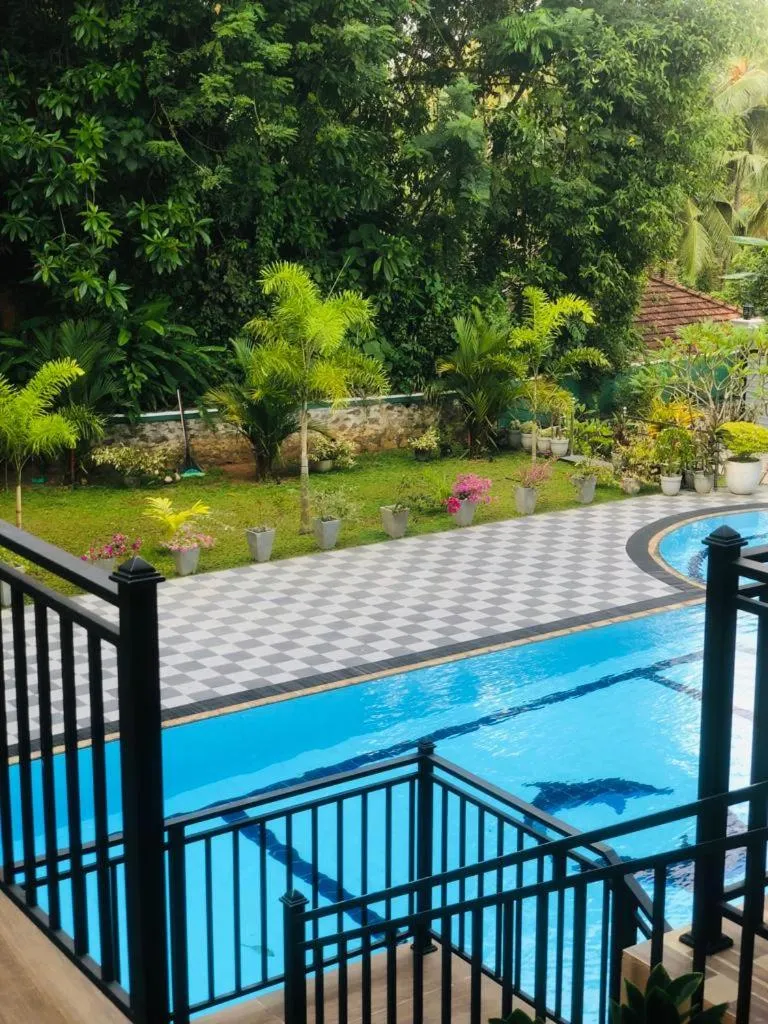 Swimming pool in Coral Palm Villa and Apartment