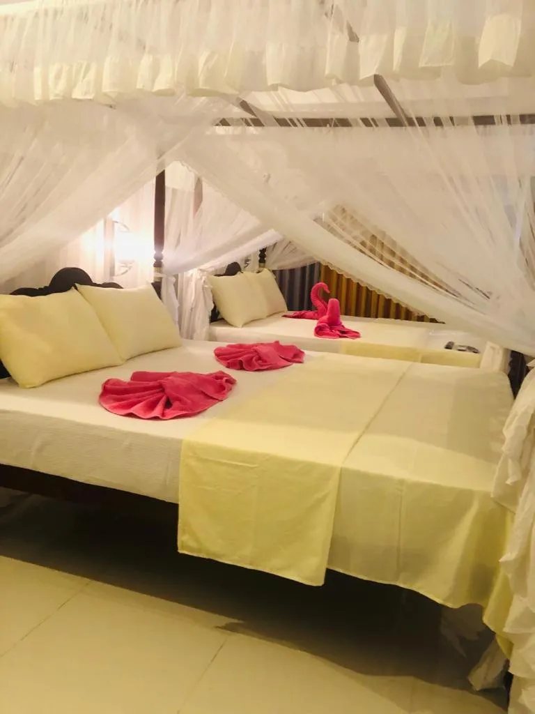 Bed in Coral Palm Villa and Apartment