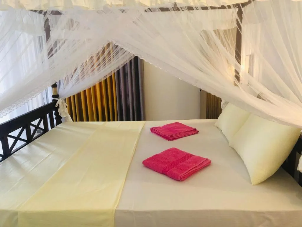 Bed in Coral Palm Villa and Apartment