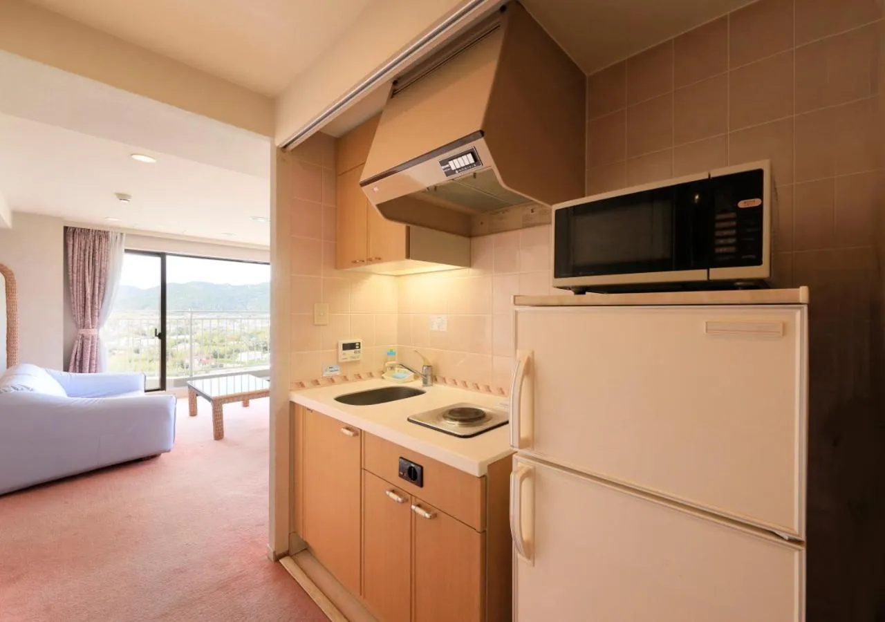 Kitchen or kitchenette, Bed in Kamogawa Grand Tower