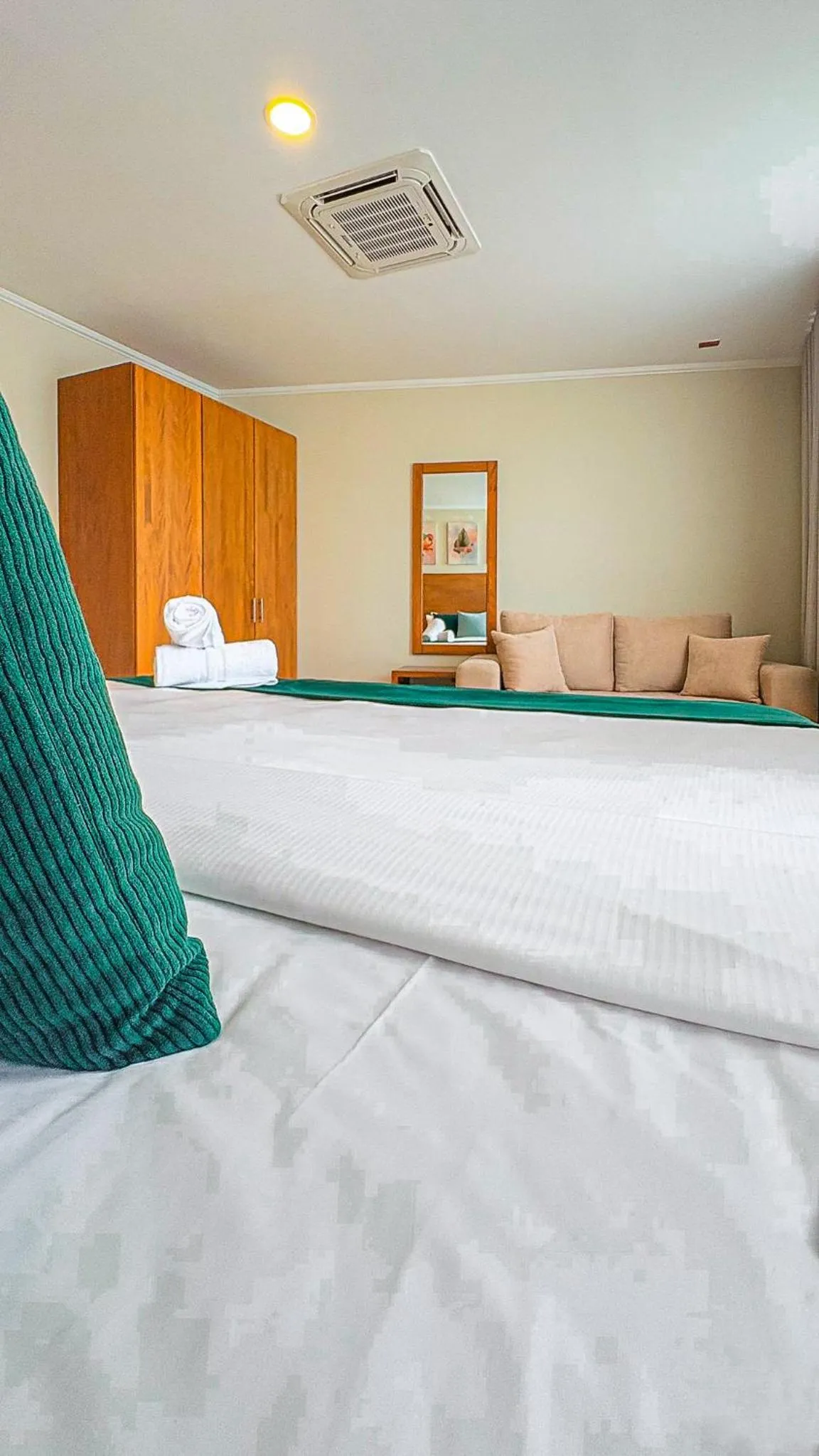 Bed in Majestic City Suites & Beach Hotel