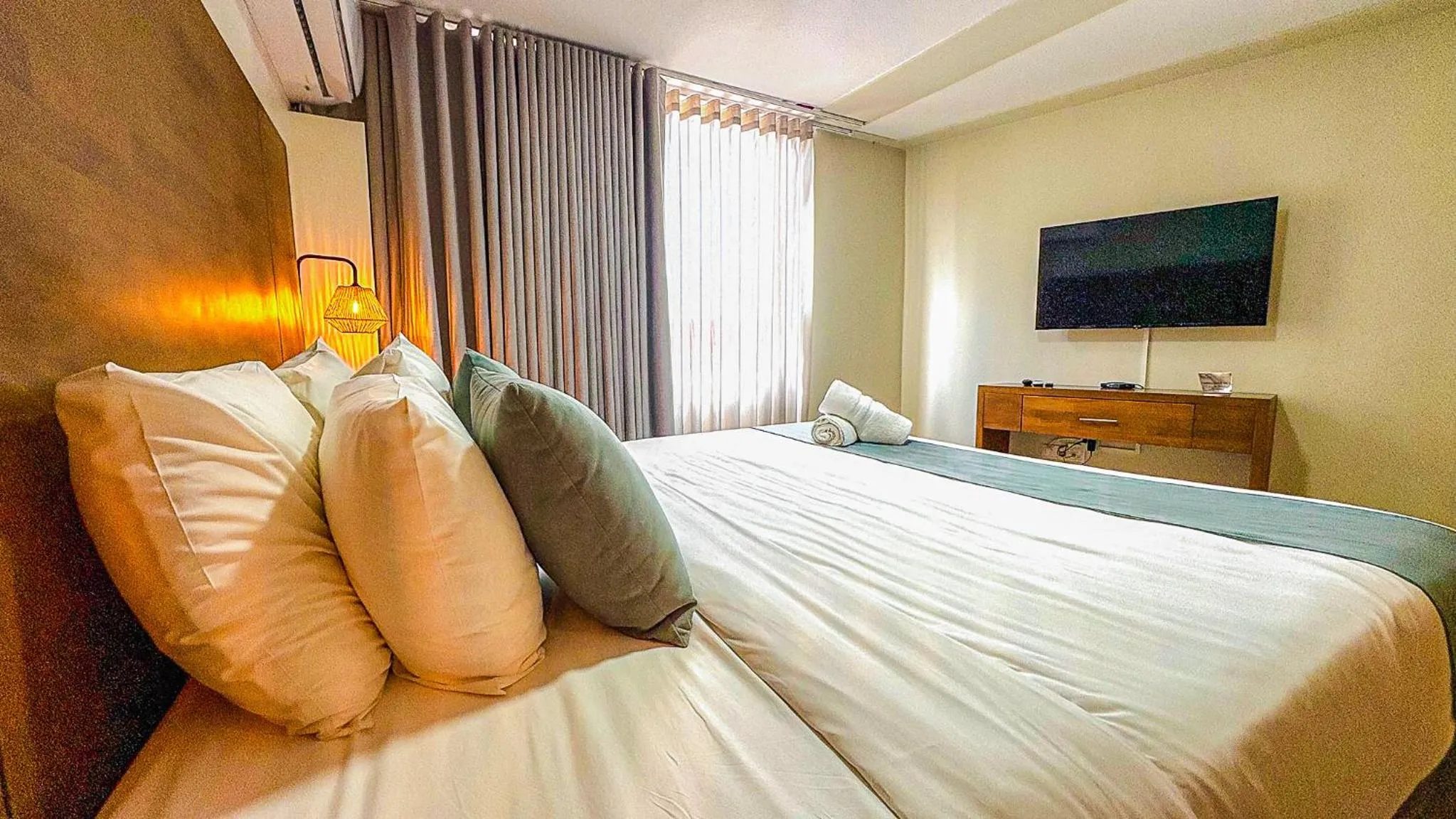 Bed in Majestic City Suites & Beach Hotel