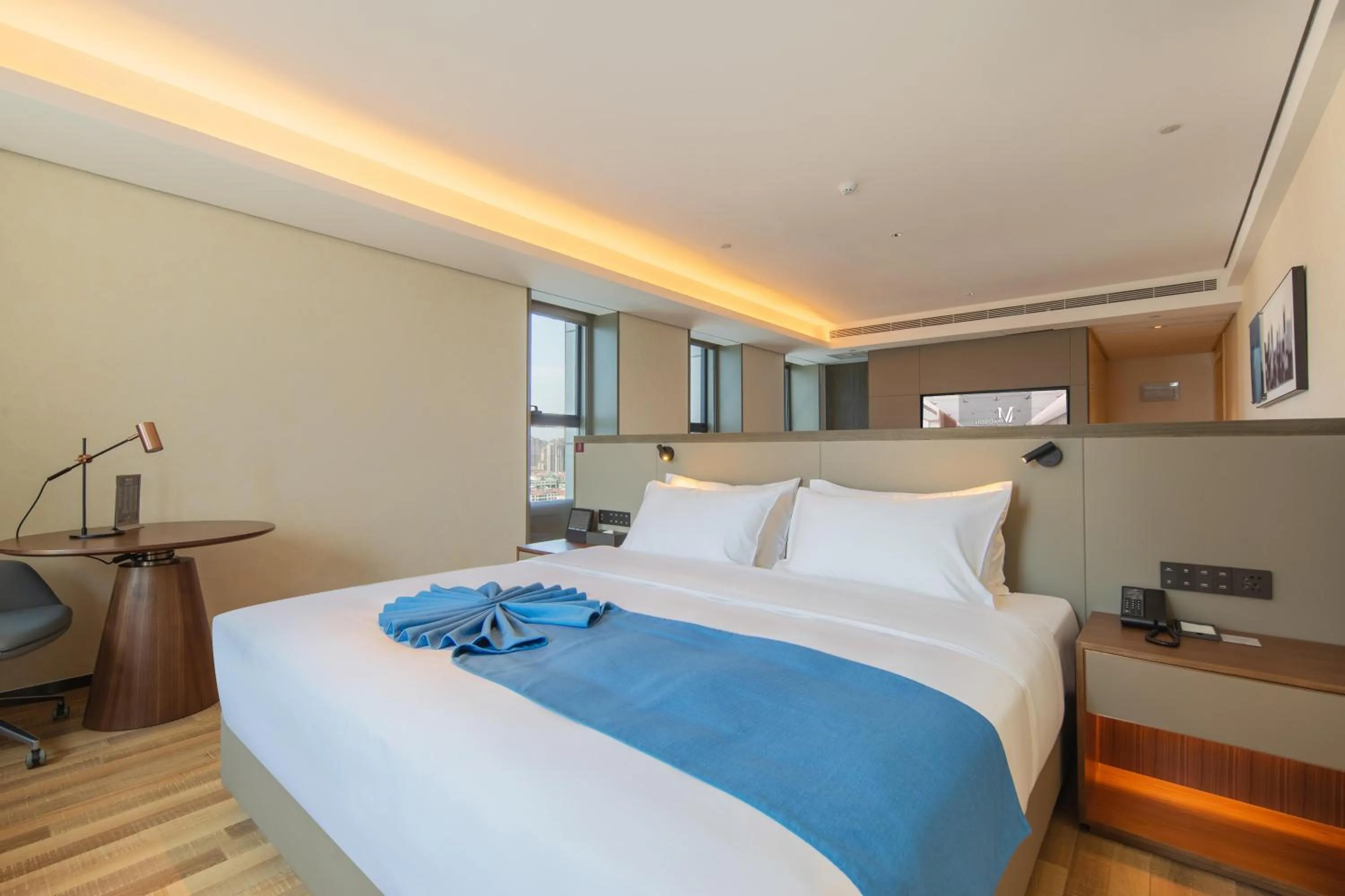 Bed in Madison Hotel Qingdao West Coast City Balcony