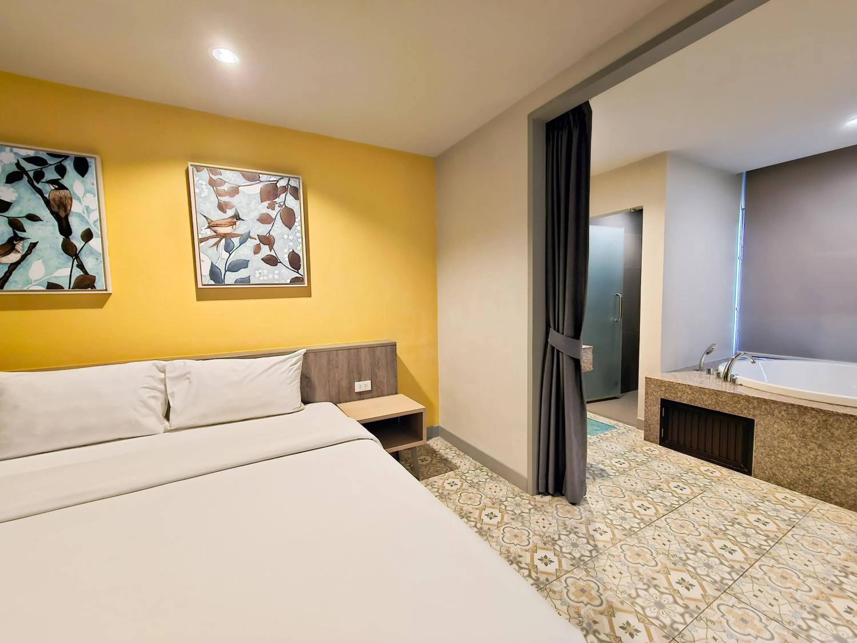 Bed in Recenta Suite Phuket Suanluang