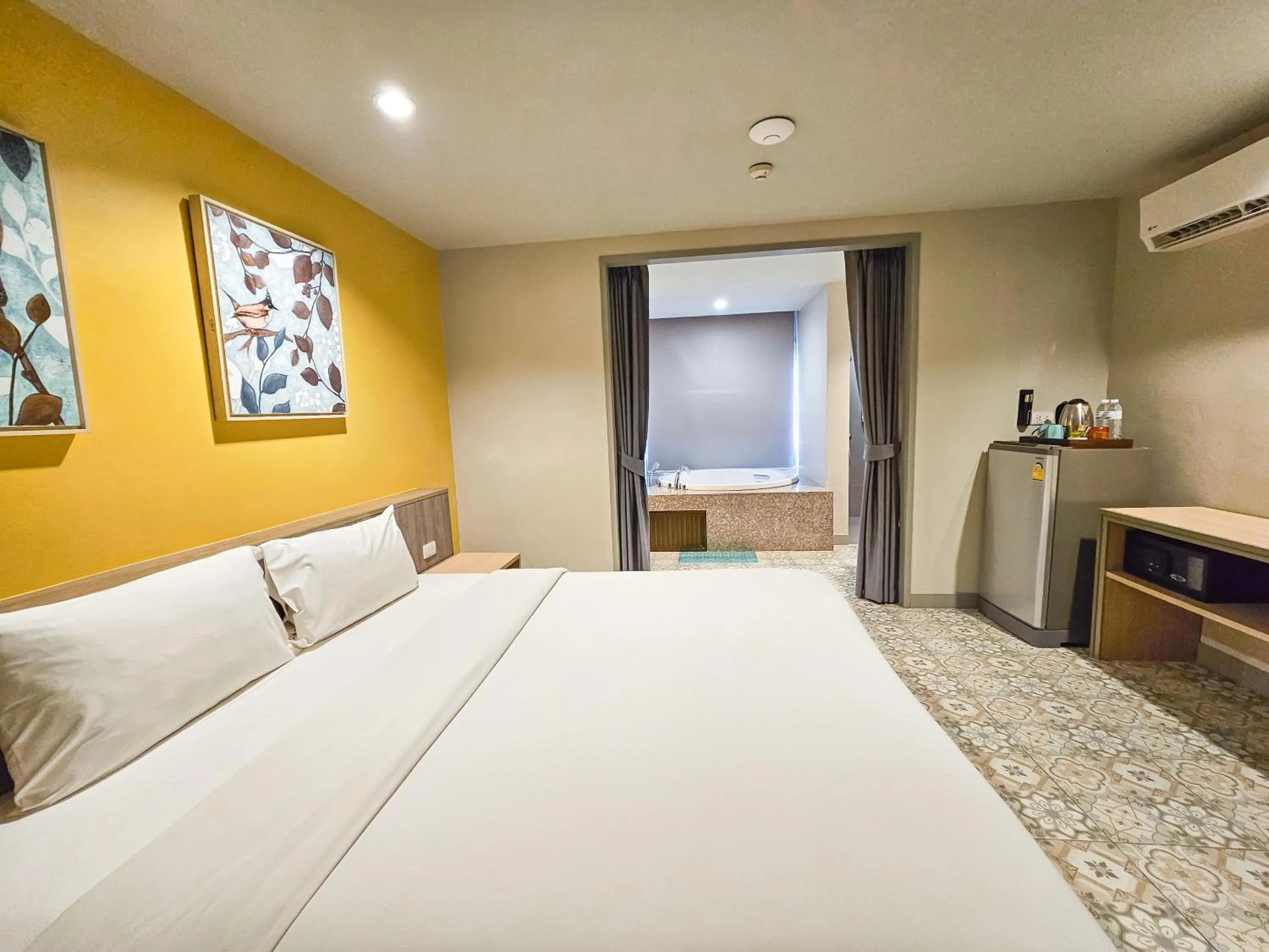 Bed in Recenta Suite Phuket Suanluang