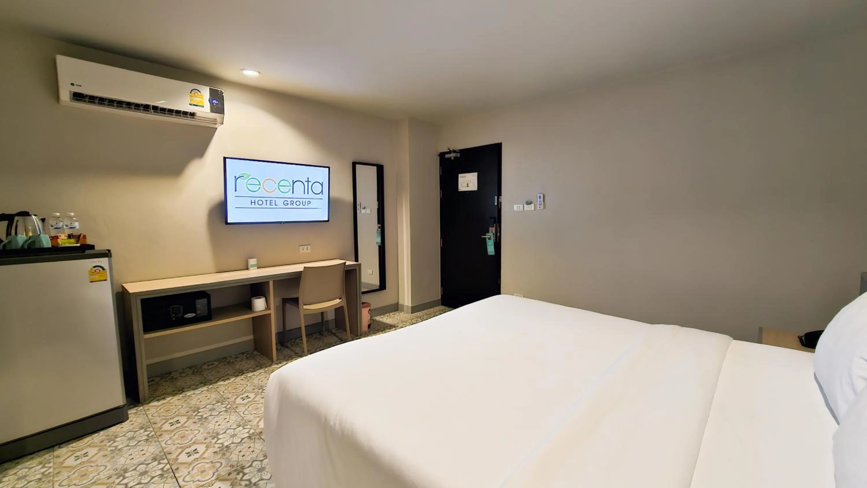 Bed in Recenta Suite Phuket Suanluang