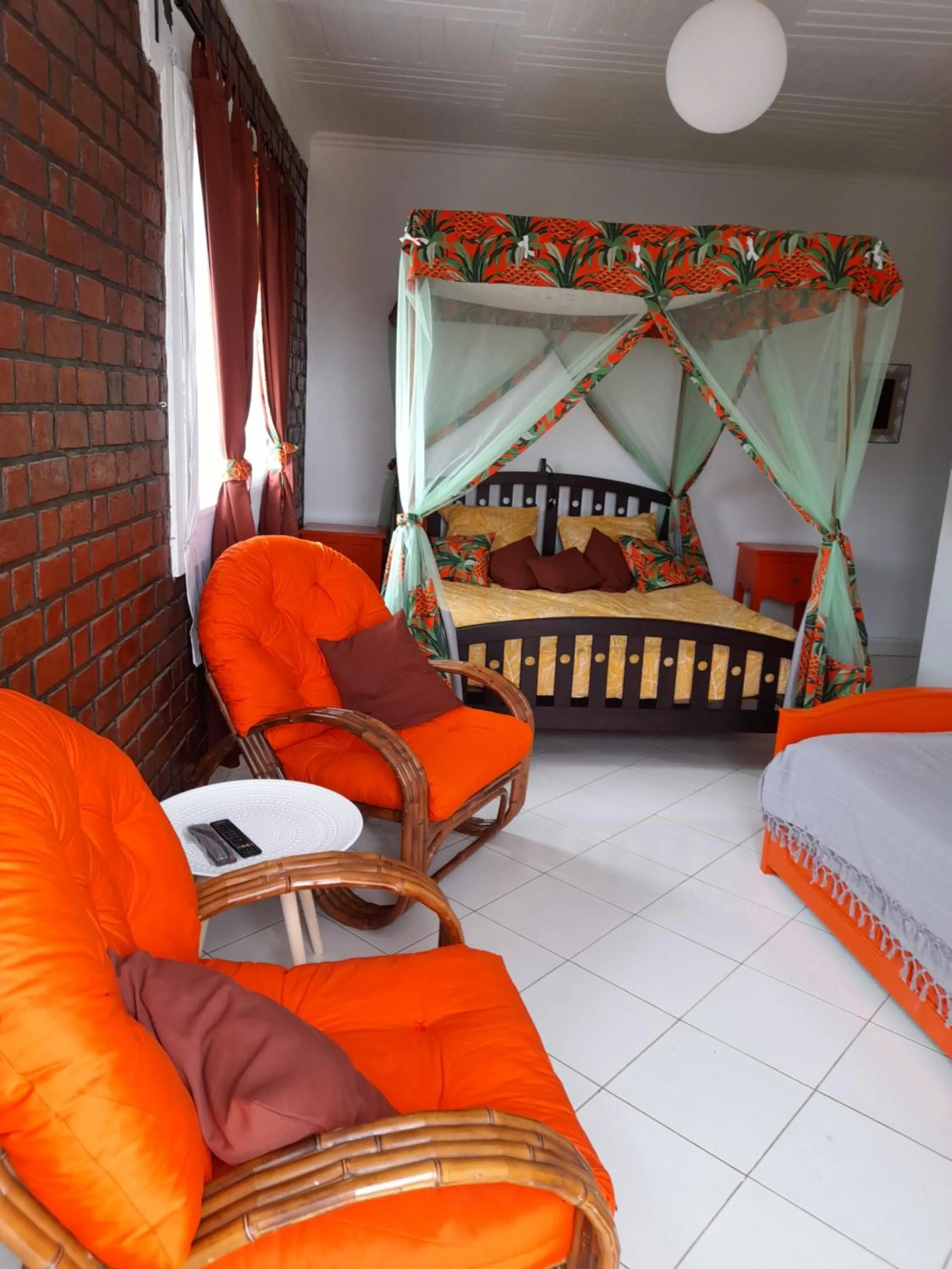 Seating area, Bed in Avamada Lodge