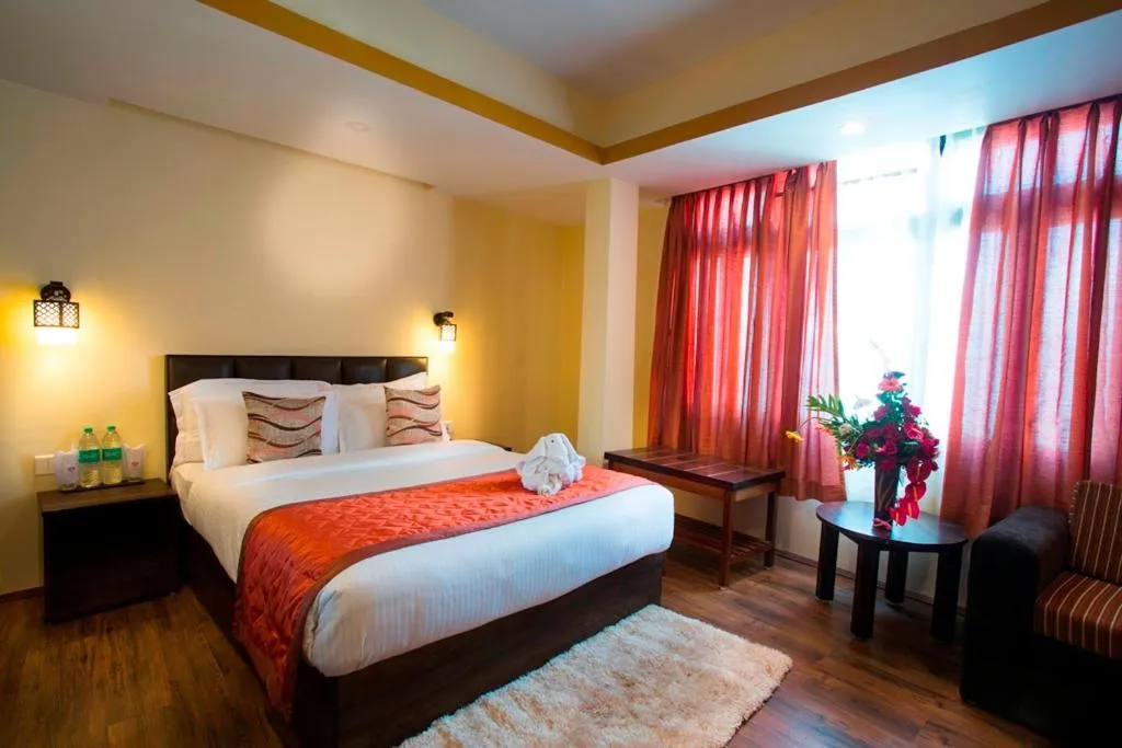 Photo of the whole room, Bed in New Orchid Lords Inn Gangtok
