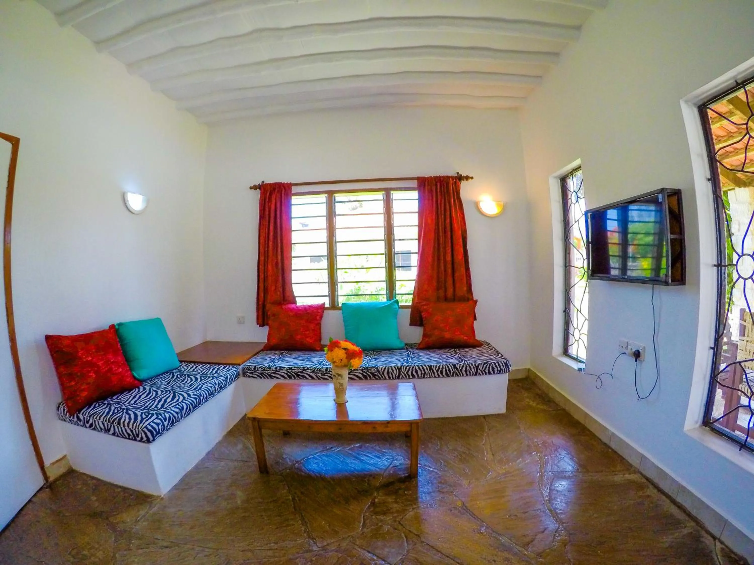 Communal lounge/ TV room in Doric Cottages Diani