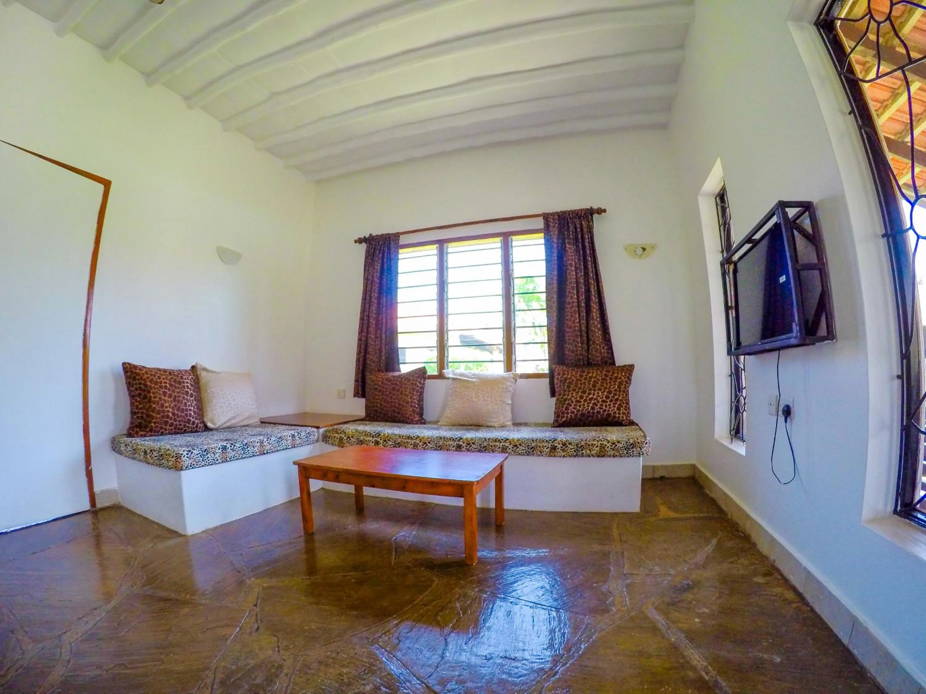Communal lounge/ TV room in Doric Cottages Diani