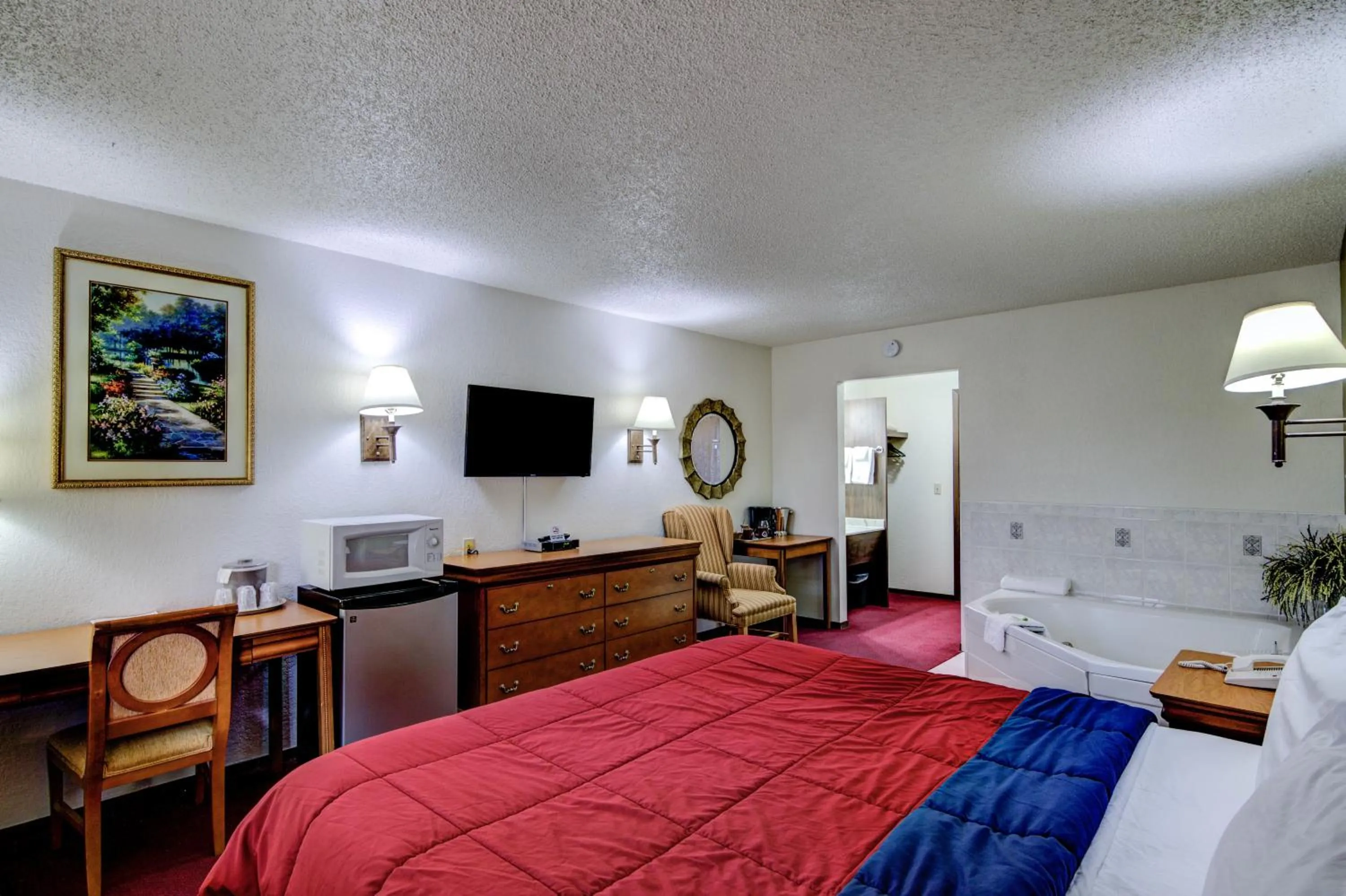 Bed in Bloomer Inn & Suites