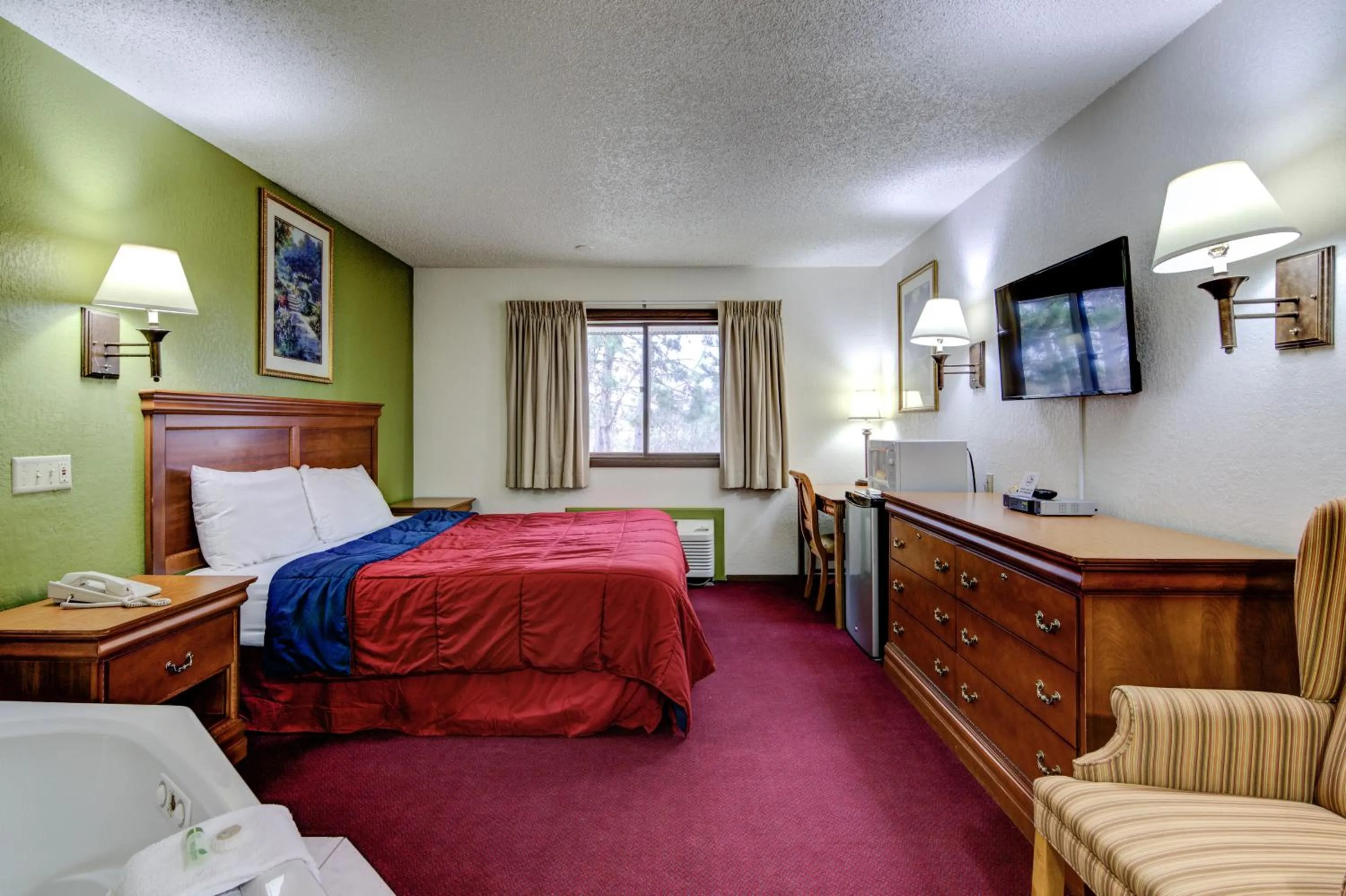 Bed in Bloomer Inn & Suites